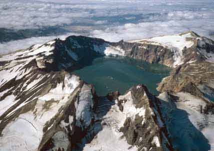 aerial view of a crater lake in a snowy mountain