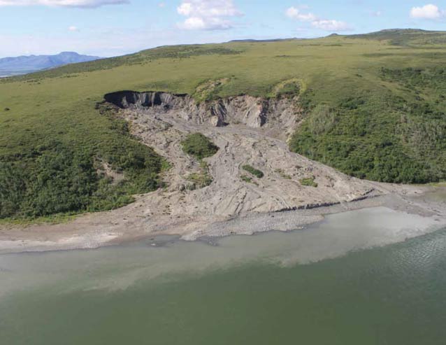 tree-less hillside partially collapsed into a river
