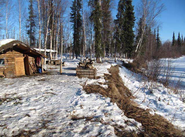 log cabin near a frozen lake
