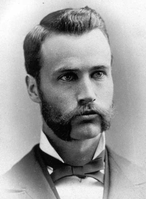 black and white image of a man in a tie and jacket