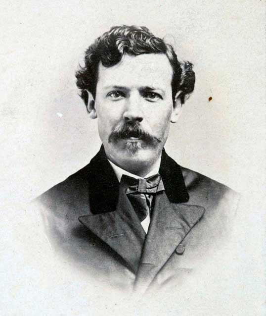 black and white portrait photo of a man in dress clothes