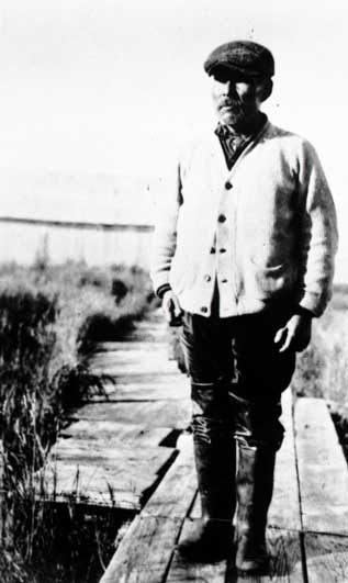 man standing on a wood boardwalk