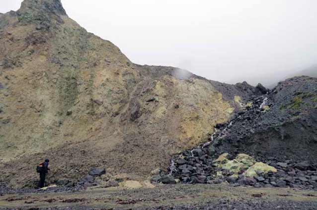 man walking through a rocky landscape