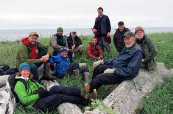 group of people sitting in a field