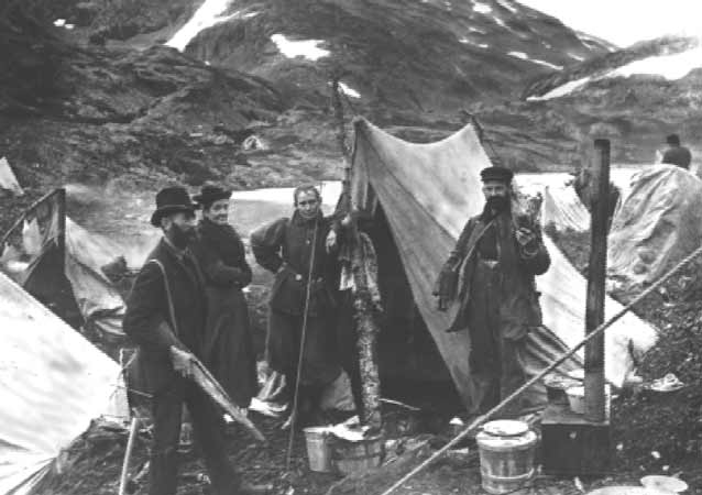Men and women setting up camp on the trail