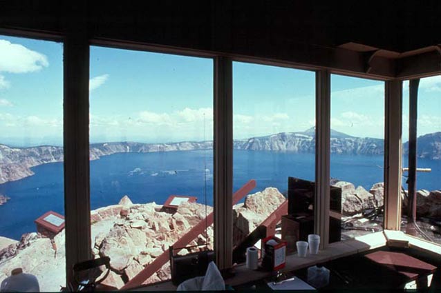 A view from within the Observation Station includes the rocks outside and bright blue lake beyond.
