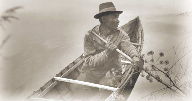 Illustration of a man sitting in boat and paddling