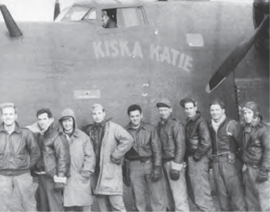 A group of men stand pose for photo in front of an airplane. A group of men stand pose for photo in front of an airplane.