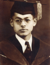 Image of young man in wearing a cap and gown dressed for a graduation ceremony.