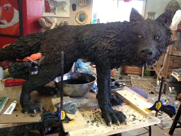 Finished wolf sculpture on work bench. Finished wolf sculpture on work bench.