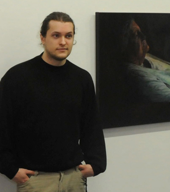 Man stands by painted portrait of elderly woman