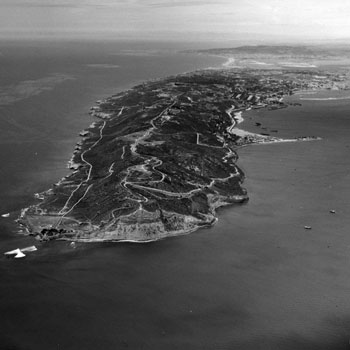 B&W aerial view showing peninsula sticking out into a bay and ocean