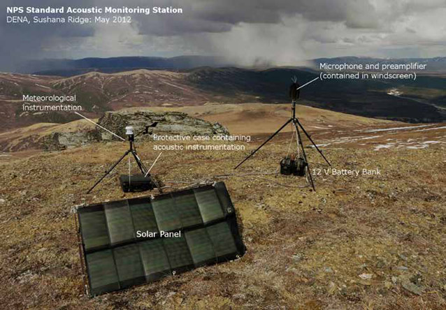 solar panels and tripods on a tree-less hilltop