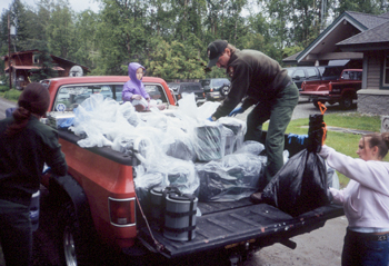 a truck is loaded with bagged clean mountain cans