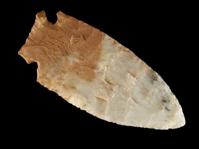 Hafted knife blade made of chert on a black background
