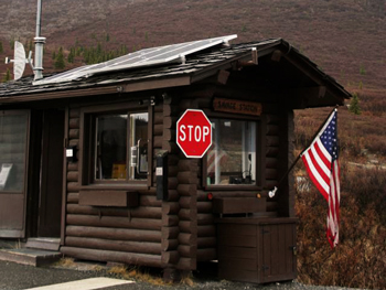 a log check station with the american flag hanging outside
