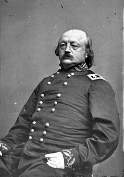 Portrait of a bald, mustached general with a double-breasted uniform jacket.