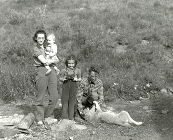 The Murie family stand for a family picture by the shore of a river The Murie family stand for a family picture by the shore of a river