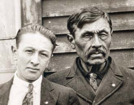 Two men, a young man and an older man, pose for camera Two men, a young man and an older man, pose for camera
