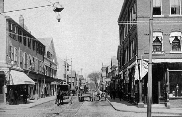 Horse-drawn carts on a cobblestone road with trolley tracks. Horse-drawn carts on a cobblestone road with trolley tracks.
