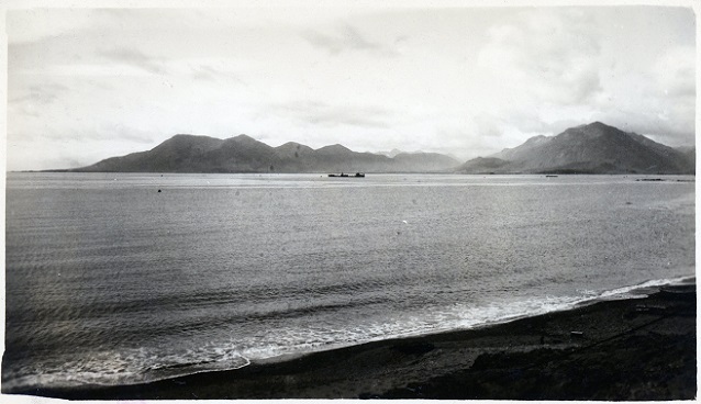 Bay and mountains on a clear day with a ship in the distance