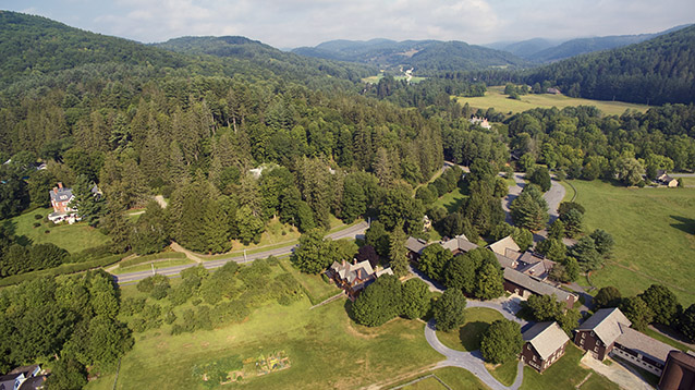 Aerial view of park landscape with mountains, buildings, and roads.