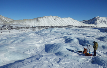 a researcher stands on a glacier a researcher stands on a glacier