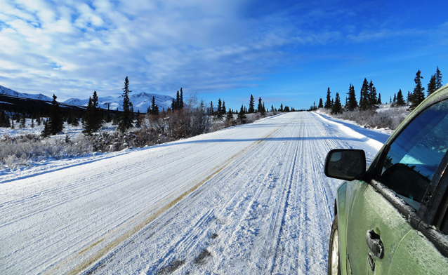 a car sits on a snow covered road