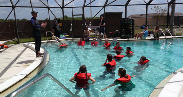 Group of trainees in a swimming pool.