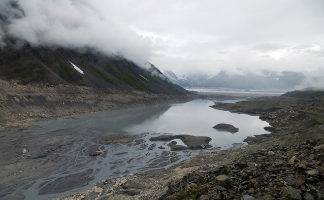 clouds hang low over a rocky lake