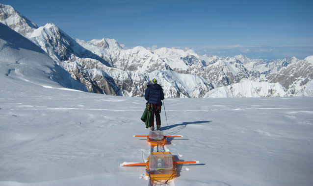 Scientist pulls ice penetrating equipment across the snow. Scientist pulls ice penetrating equipment across the snow.