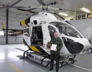 Man standing in front of a helicopter