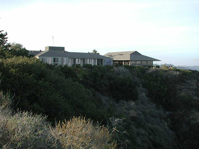 view of Visitor Center on a grassy cliff looking west