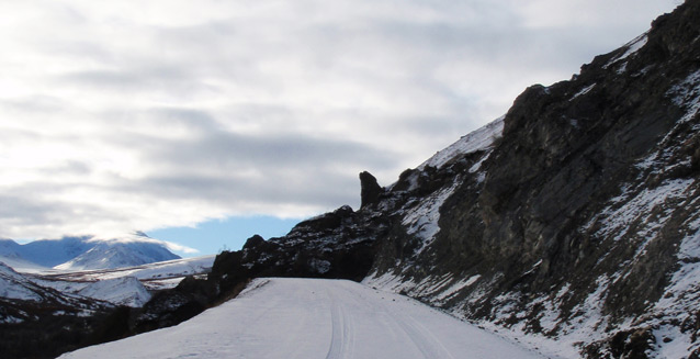 a rocky debris slide covers a snowy road a rocky debris slide covers a snowy road