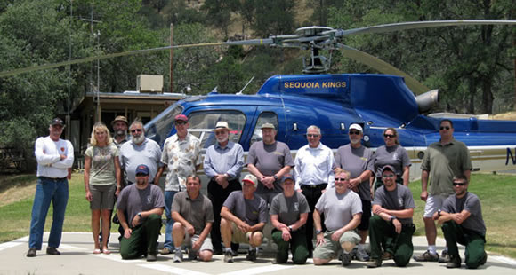 Group photo of pilots in front of a helicopter