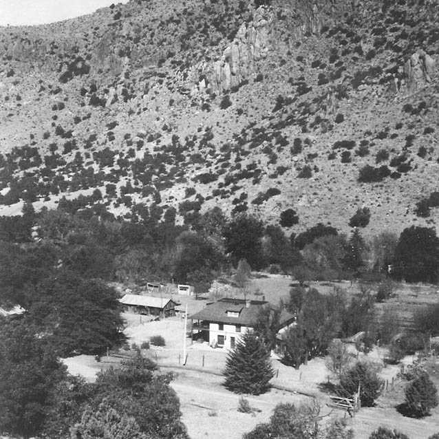 Aerial view of buildings at the base of a steep hillside