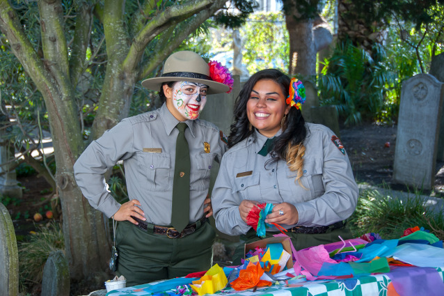 Two rangers, one wearing Dia de los Muertos make-up and both wearing colorful flowers in their hair Two rangers, one wearing Dia de los Muertos make-up and both wearing colorful flowers in their hair