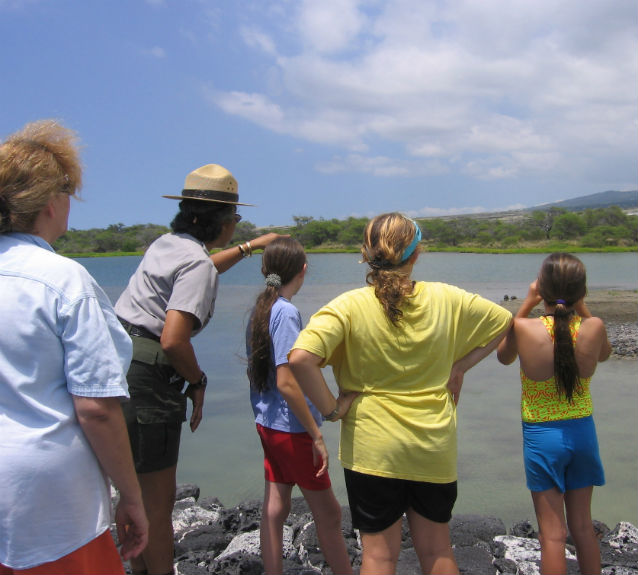 a ranger talking to several girls and women