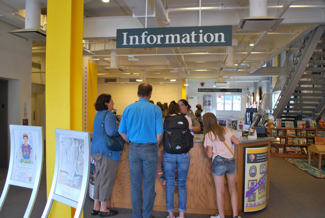 family standing at an information desk