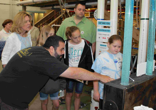 scientist showing how ocean acidification experiments work