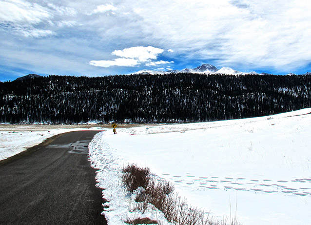 Longs Peak in the background of a snowy field Longs Peak in the background of a snowy field