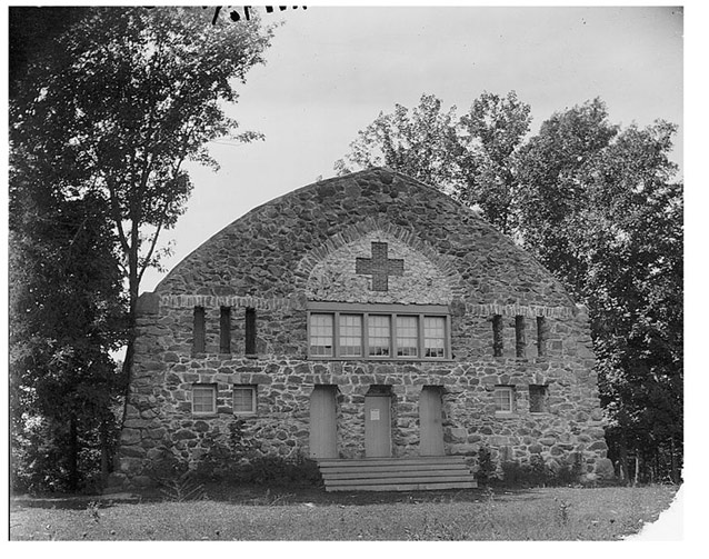 The house had a massive granite facade and a brick cross over the doors. 