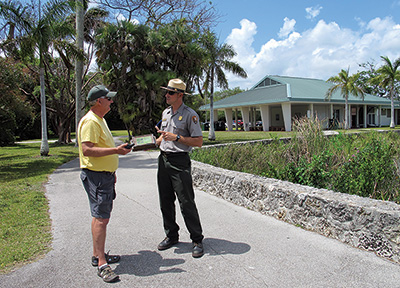 A park ranger talks with a park visitor along the Anhinga Trail (Credit: NPS Photo)