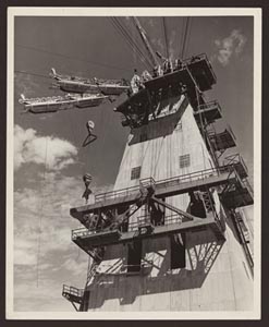 A black and white photo of the headway tower with a cable system