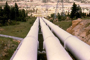 Image of three long and wide pipes extending a few hundred feet