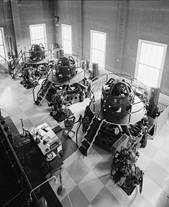 Black and white photo of engineers working inside the power plant