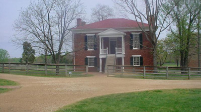 Steps lead to the second-story entry door on a square brick building. Steps lead to the second-story entry door on a square brick building.