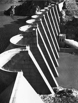 A black and white photo close up of the arches and buttresses of Bartlett Dam