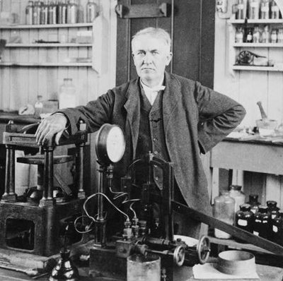 Black and white photo of Thomas Edison with his arm resting on the telephone Black and white photo of Thomas Edison with his arm resting on the telephone