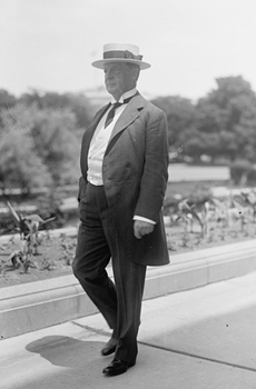 Black and white photo of  senator Francis G. Newlands taking a walk on a sidewalk 